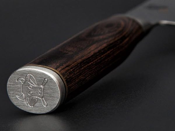 KAI Shun Premier Tim Mälzer Santoku mit 18 cm Klinge. VG-MAX Stahlkern (61 HRC), 32 Lagen Damast, hochglanzpoliert mit Hammerschlagoberfläche. Griff aus gemasertem Pakkaholz in Mittelbraun. Das Präzisionswerkzeug aus Japan.